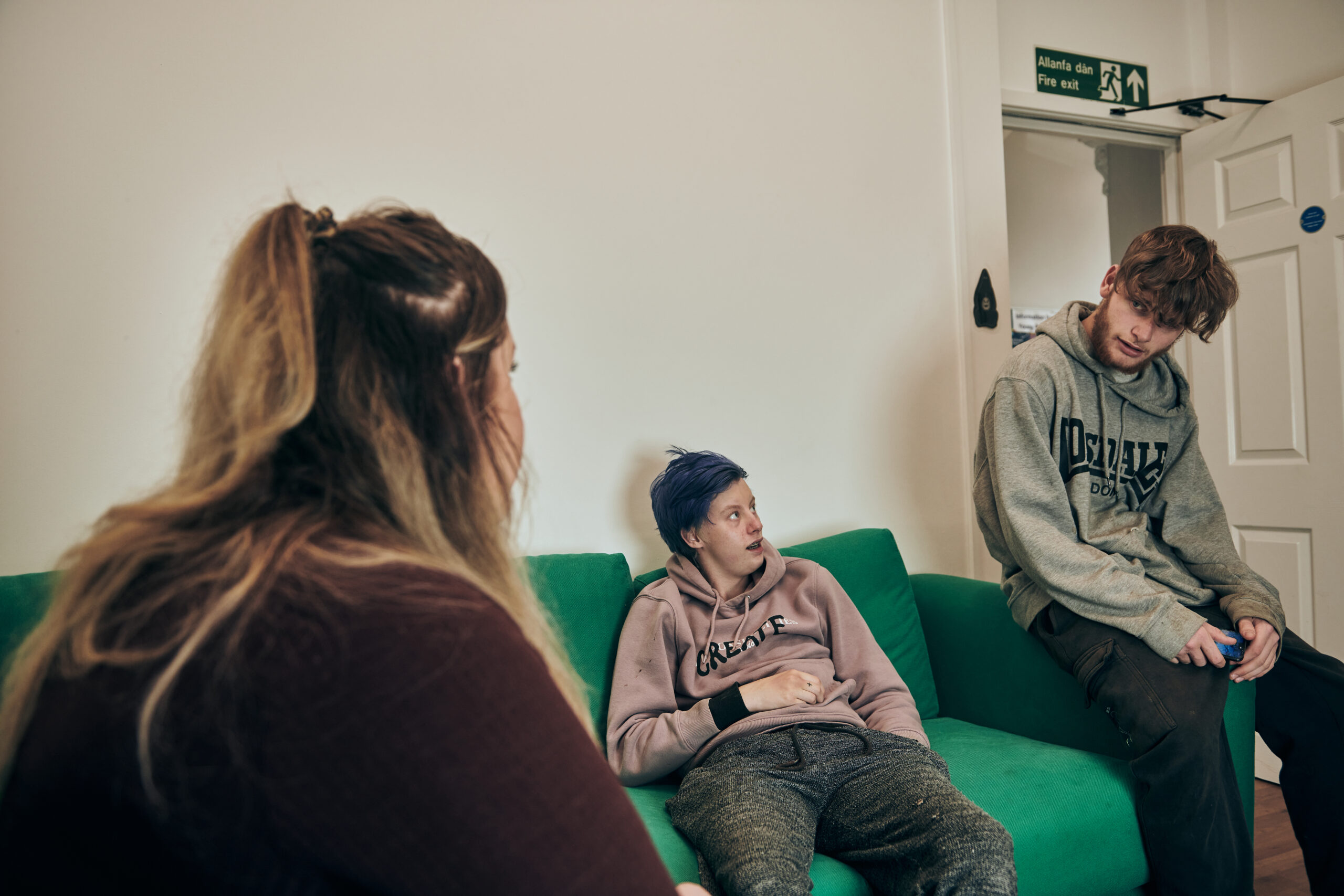 Young people talking to female staff member in homeless residential project in Bridgend (2)