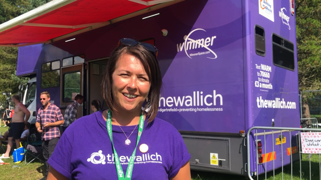 Sian Aldridge, Director of Services and Support at The Wallich stands in front of The Wallich purple vehicle in purple t-shirt