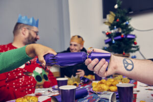 People pulling christmas cracker