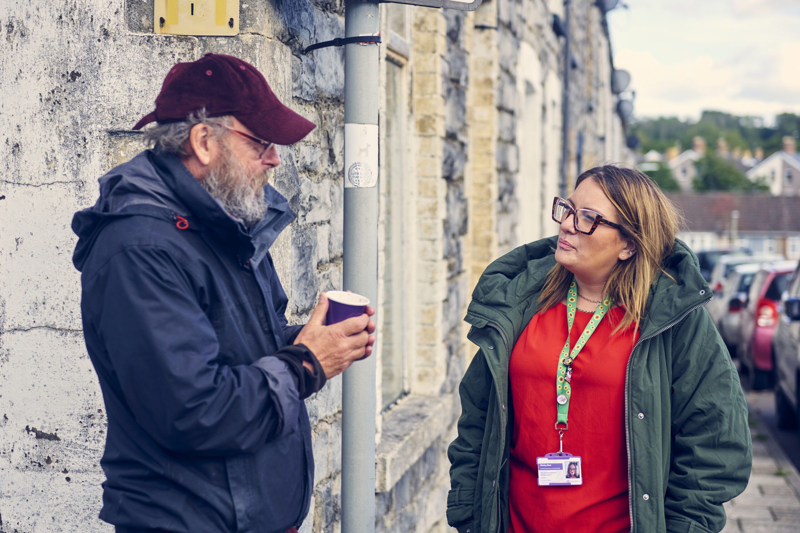 handing service user a warm drink