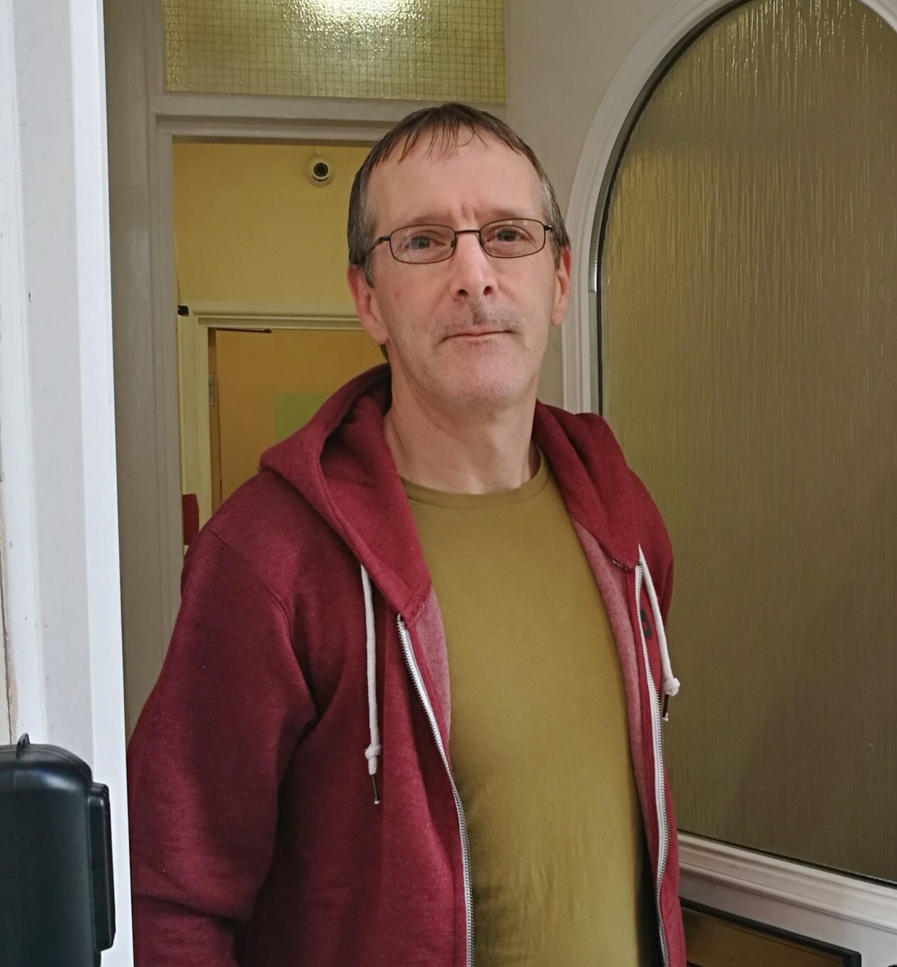 Man standing at open door