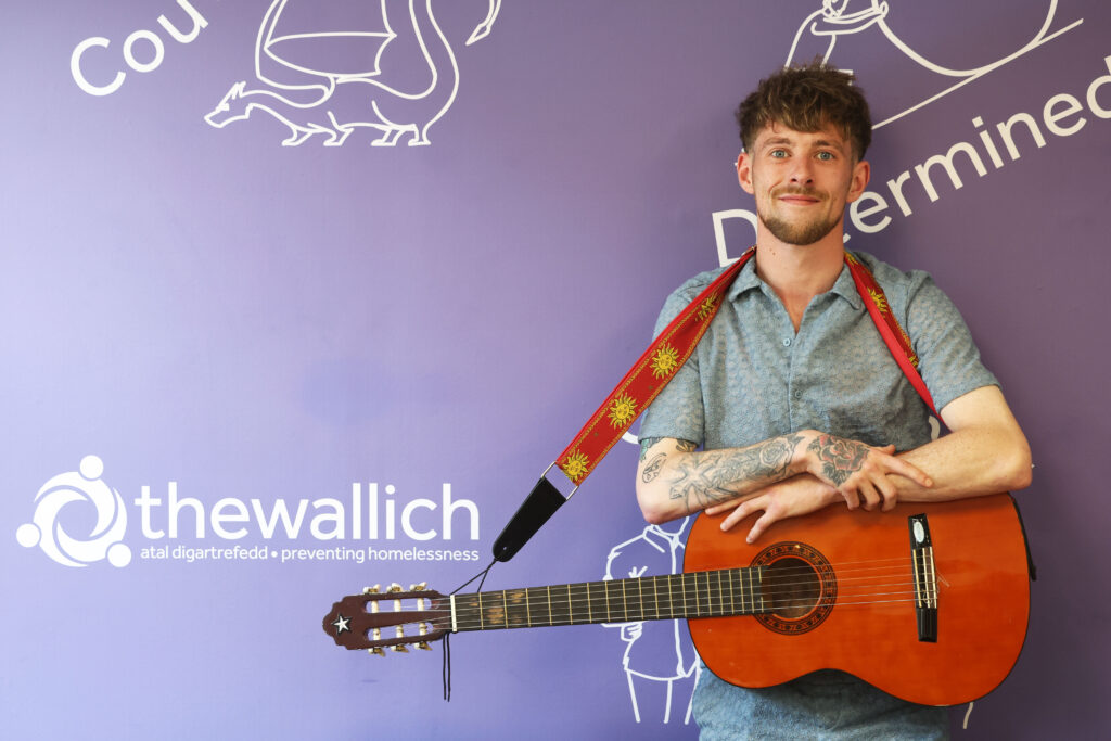 Osian holding guitar