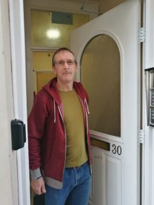 Nigel standing at a open door