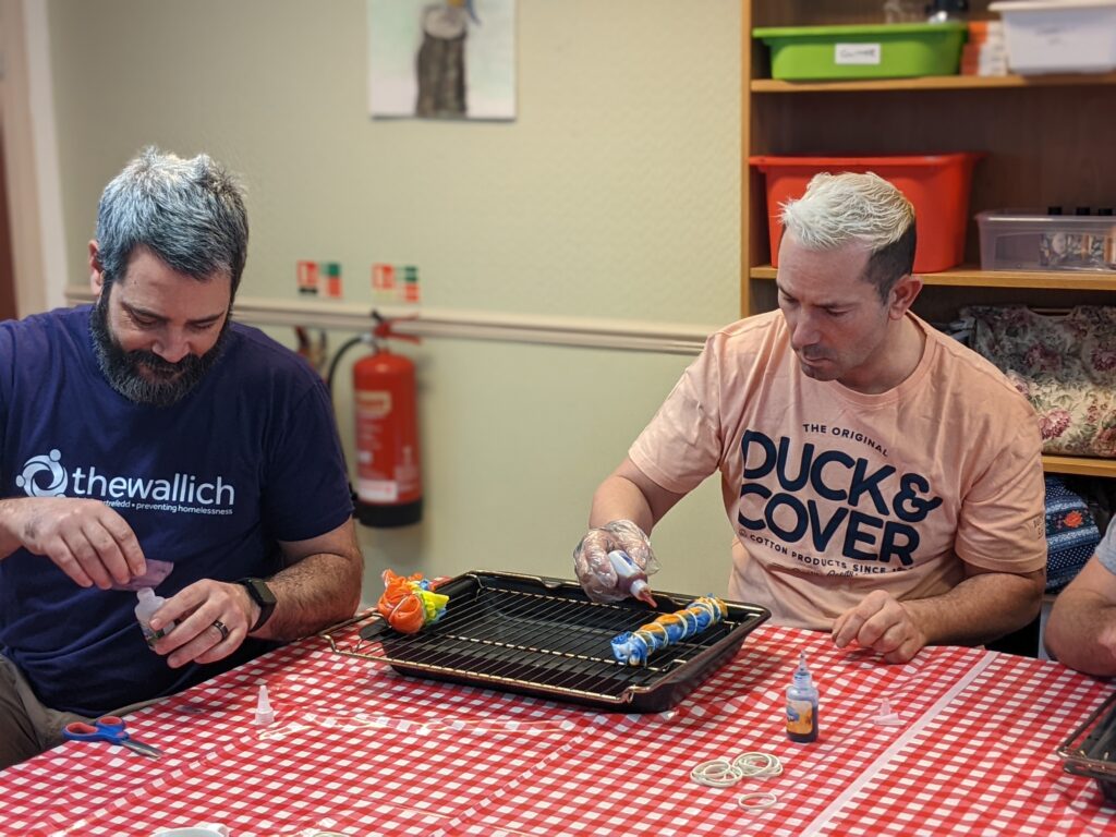The Wallich homeless art volunteering Carmarthenshire - two men are creating art at a table