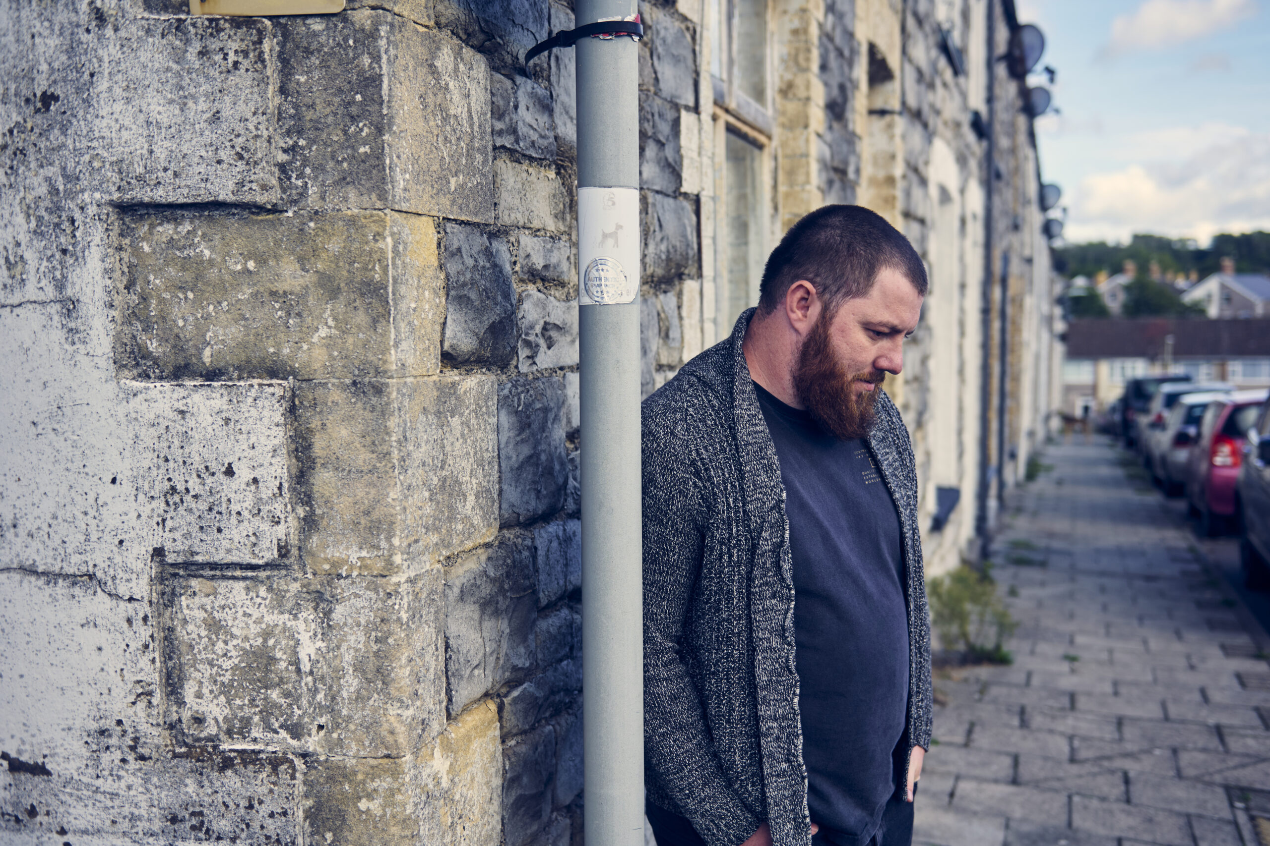 Service user leaning into lamp post