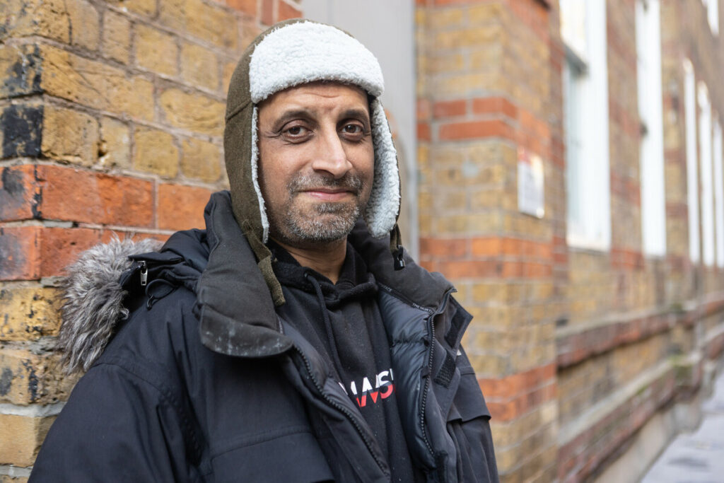 Client in woolly hat on street