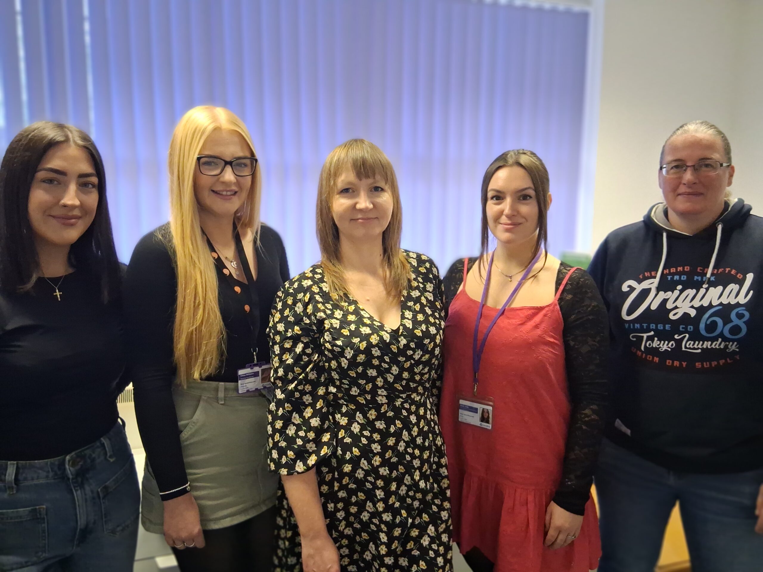 Team of 5 women stand in a row - Housing First Tai yn Gyntaf team