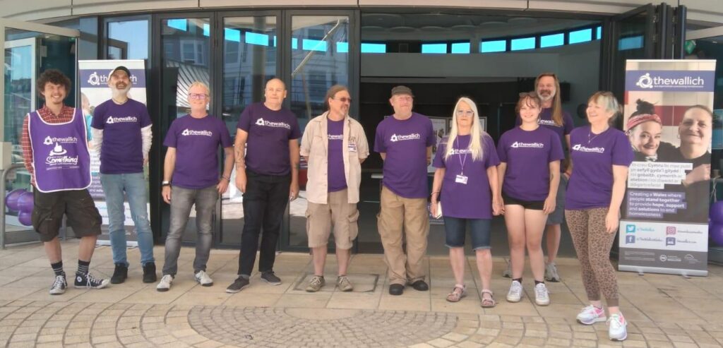 Staff and volunteers in purple t-shirts in Aberystwyth. Patrons